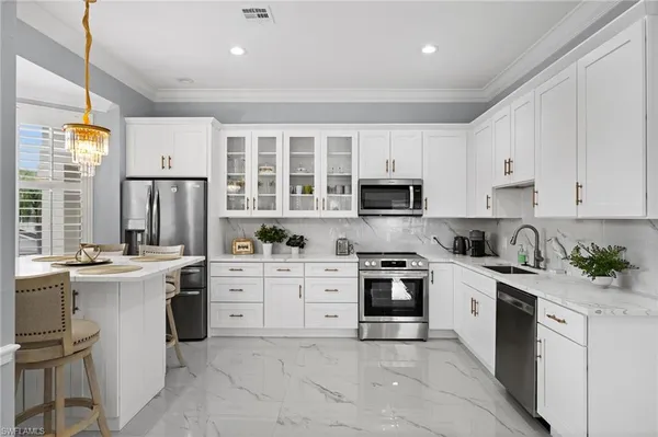 a kitchen with a stove top oven sink and cabinets