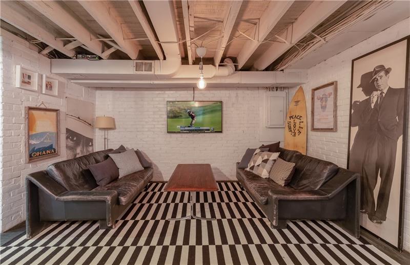 910 Glen Mitchell Road Sewickley, PA 15143 - Photo 14 of 22 The lower level is home to a stylish game room which offers an ideal space for relaxing, entertaining, exercise, home office or play and concrete floors, wainscoted and brick walls and exposed rafter ceiling.