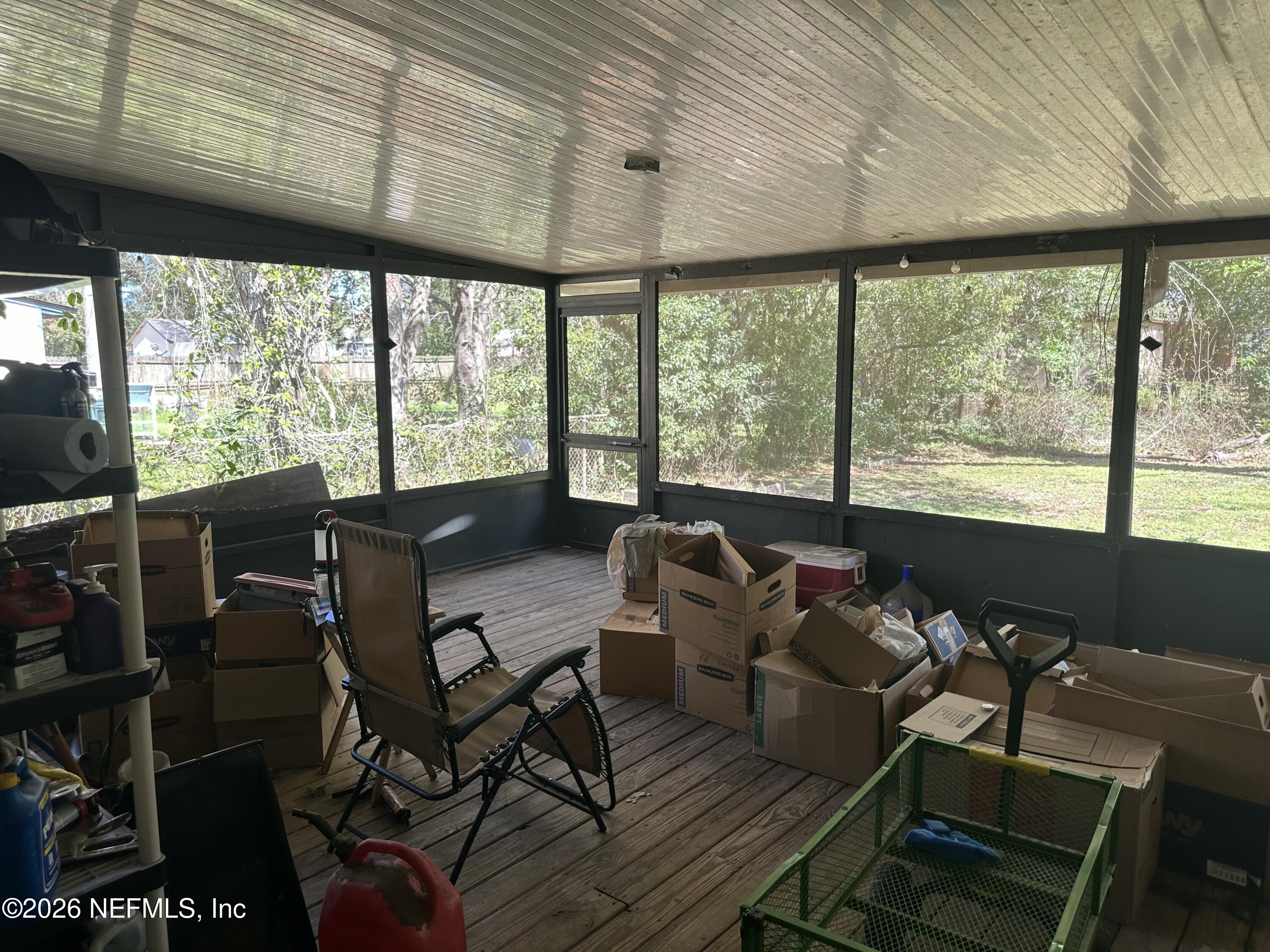 2351 Gaillardia Road Jacksonville, FL 32211 - Photo 18 of 19 a living room with furniture and a floor to ceiling window