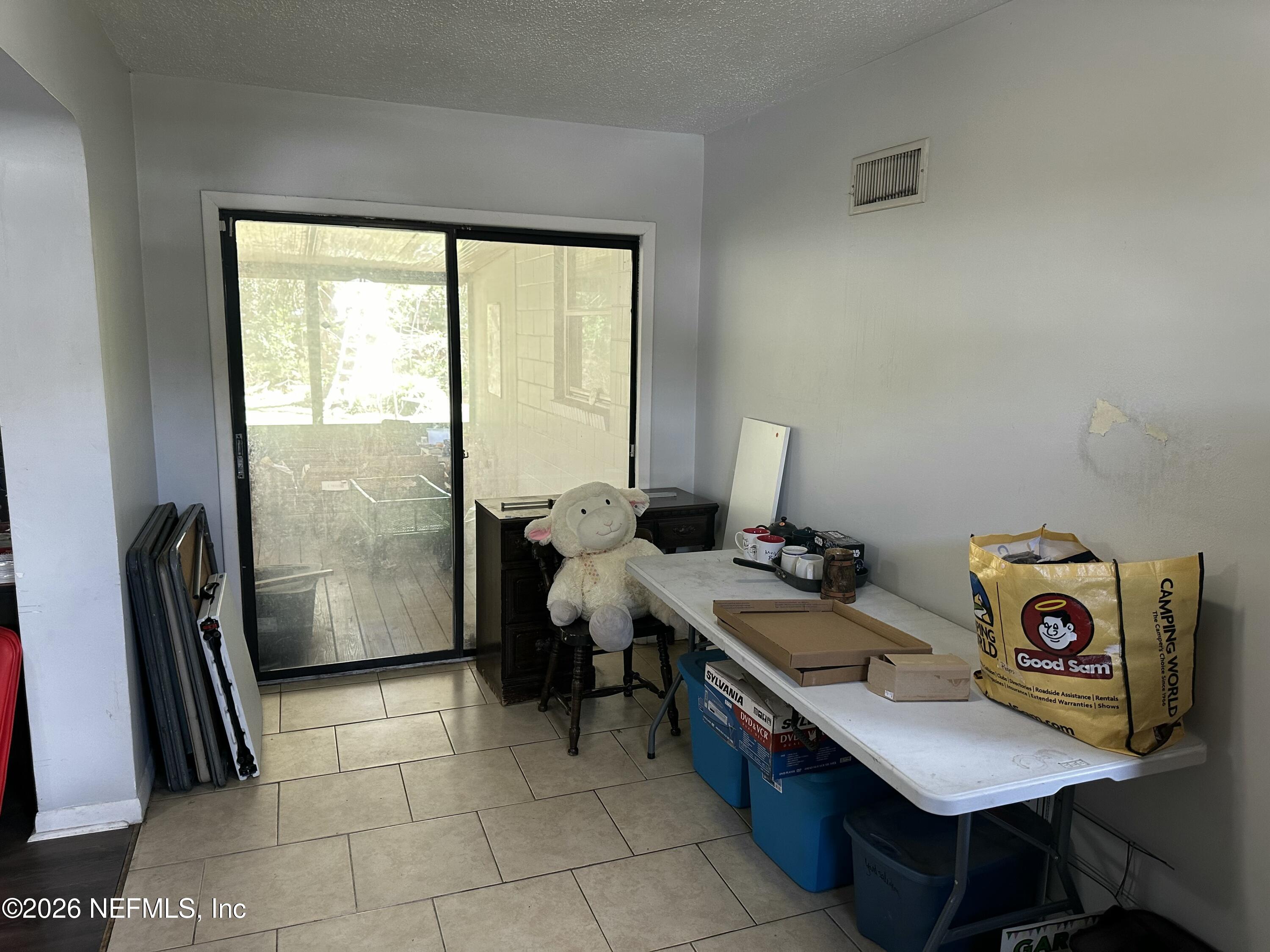 2351 Gaillardia Road Jacksonville, FL 32211 - Photo 9 of 19 a room with furniture a rug and a window