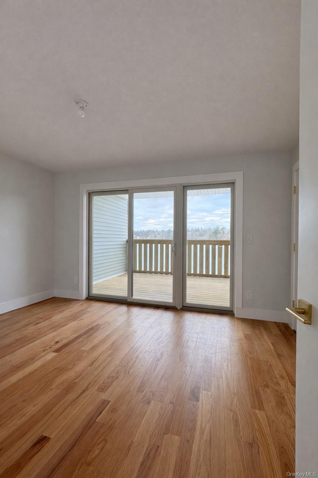 1140 Highway 52, Unit 5 Loch Sheldrake, NY 12759 - Photo 15 of 22 a view of an empty room with wooden floor and a window