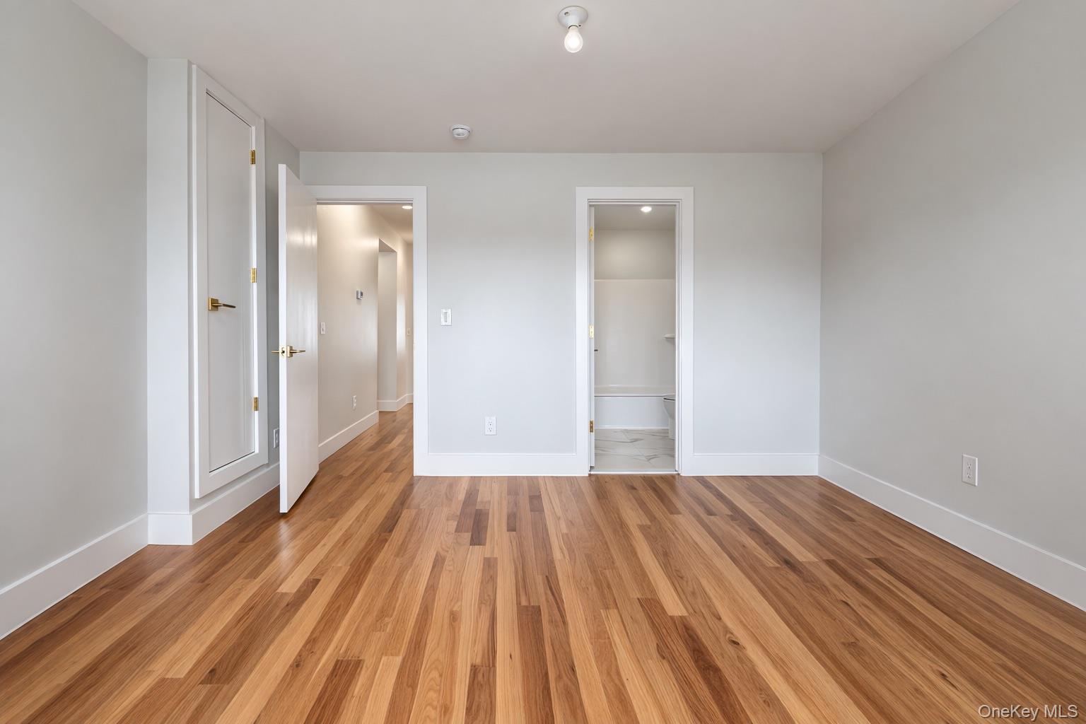 1140 Highway 52, Unit 5 Loch Sheldrake, NY 12759 - Photo 18 of 22 a view of an empty room with wooden floor and a bathroom
