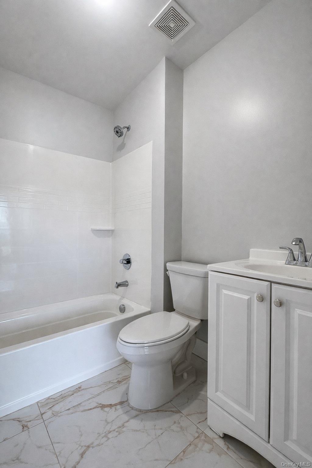 1140 Highway 52, Unit 5 Loch Sheldrake, NY 12759 - Photo 20 of 22 a bathroom with a toilet a sink and a bathtub