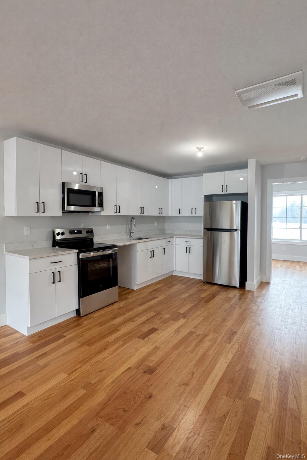 1140 Highway 52, Unit 5 Loch Sheldrake, NY 12759 - Photo 4 of 22 a kitchen with stainless steel appliances granite countertop a refrigerator oven a stove top oven and a sink