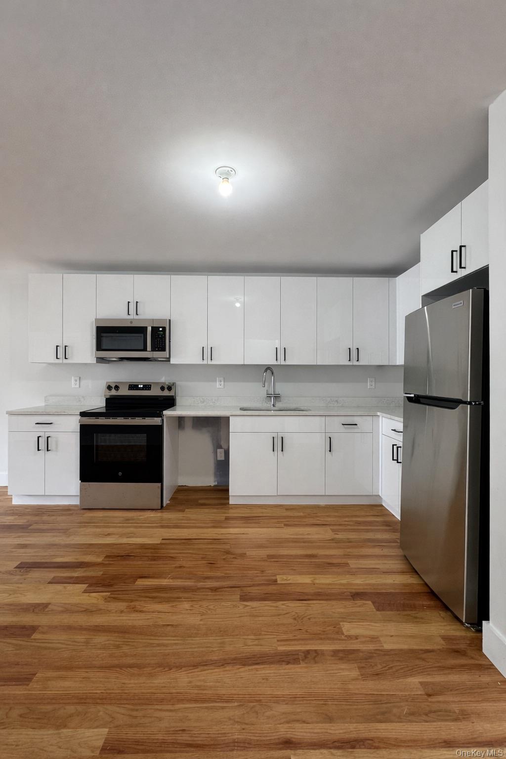 1140 Highway 52, Unit 5 Loch Sheldrake, NY 12759 - Photo 5 of 22 a large kitchen with cabinets stainless steel appliances and a counter space