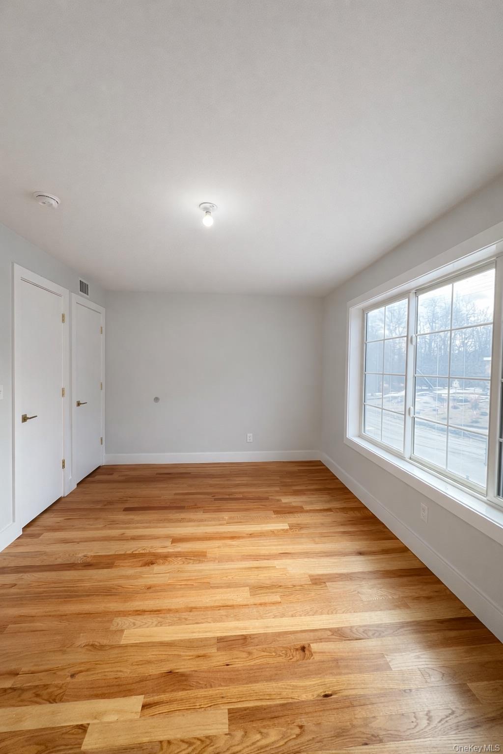1140 Highway 52, Unit 5 Loch Sheldrake, NY 12759 - Photo 9 of 22 a view of empty room with wooden floor and fan