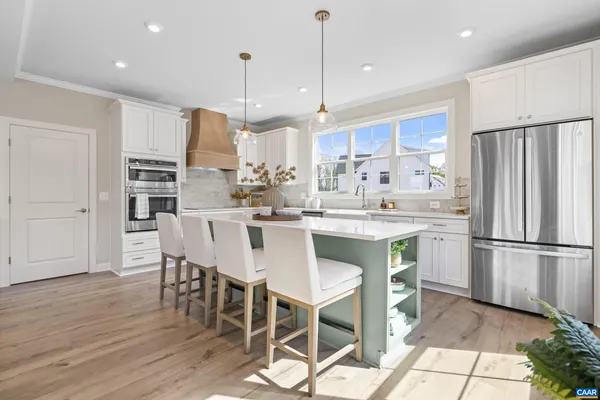 a kitchen with stainless steel appliances a refrigerator and a stove top oven