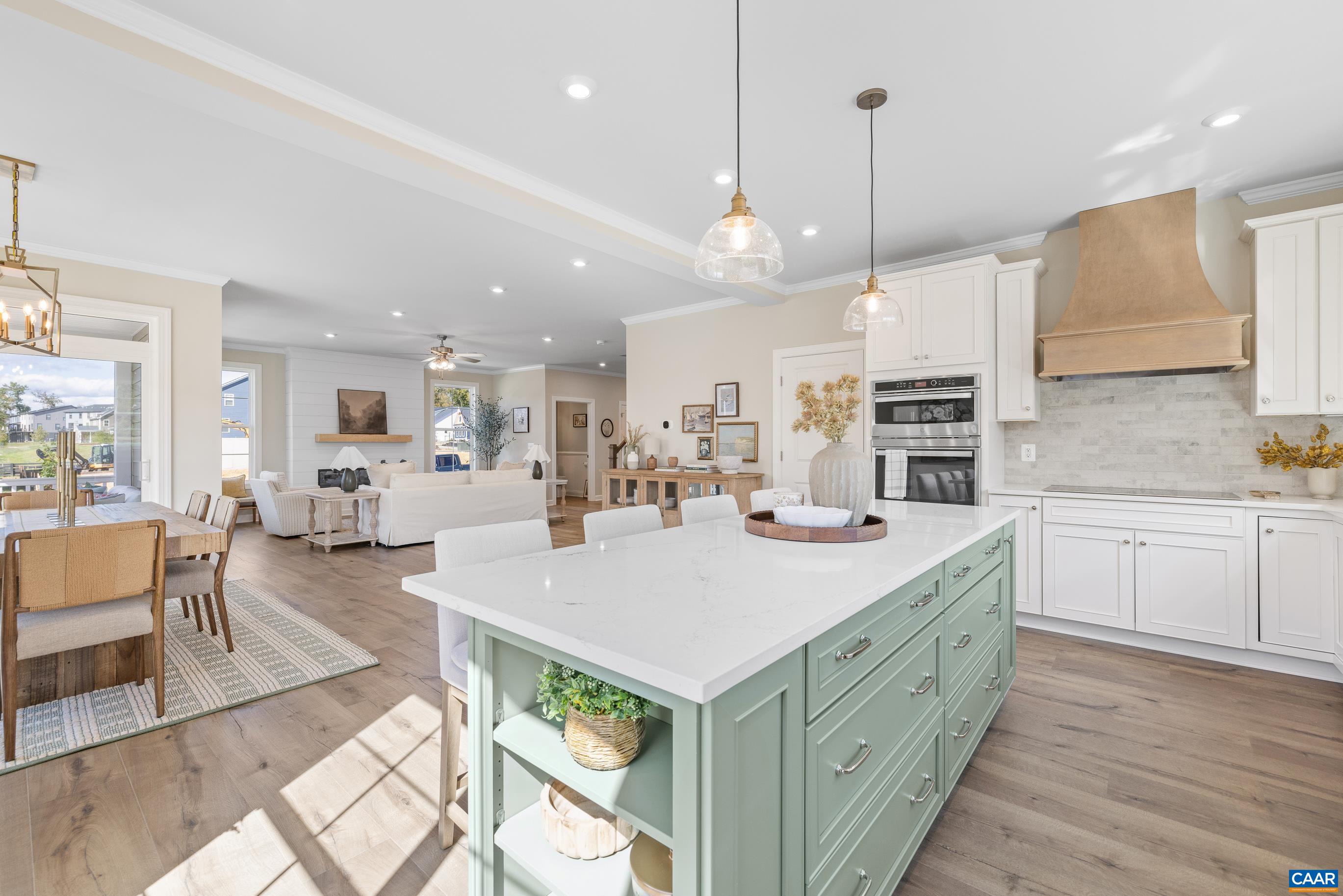 2 D Corsham Street Crozet, VA 22932 - Photo 22 of 44 a large kitchen with kitchen island a large island a sink appliances and a living room view
