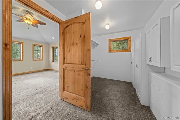 a bathroom with a granite countertop sink a toilet and a mirror