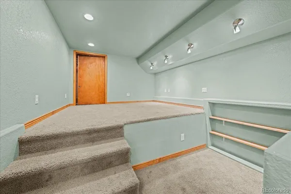 a view of a hallway with entryway and chandelier