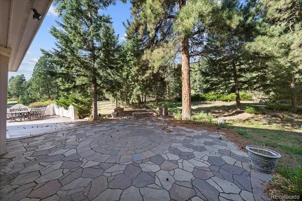 a aerial view of a house with a yard and a large tree