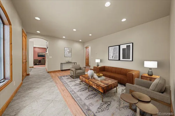 a living room with furniture a rug and a table