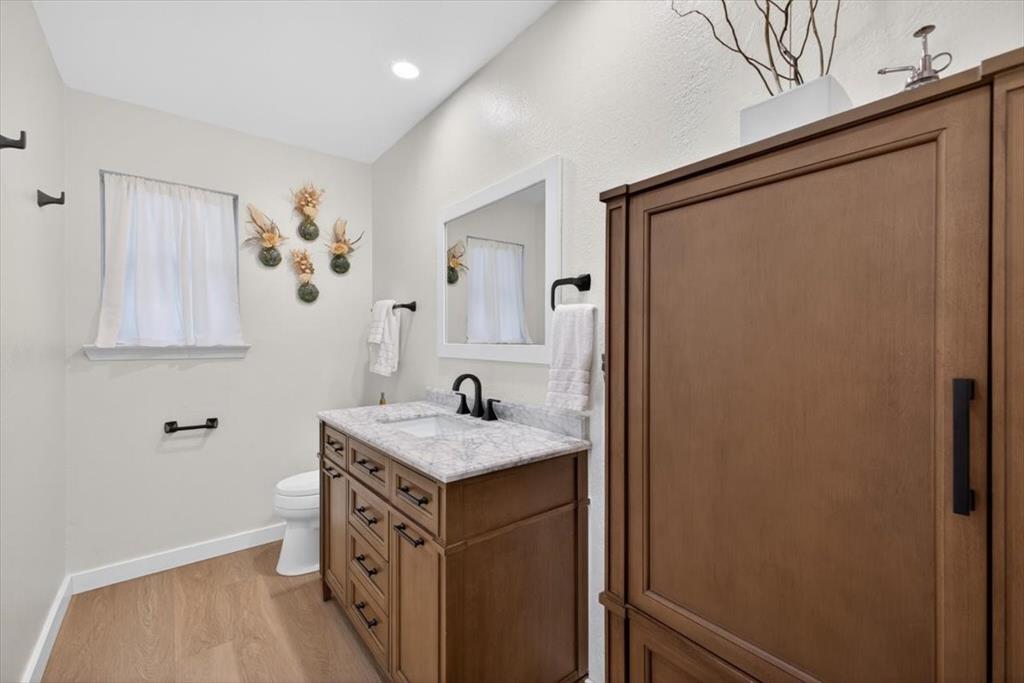 405 Pecan Street Azle, TX 76020 - Photo 18 of 33 Bathroom with vanity, light wood-style floors, and recessed lighting