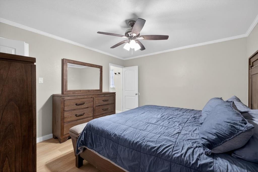 405 Pecan Street Azle, TX 76020 - Photo 23 of 33 Bedroom featuring ornamental molding, light wood-type flooring, and ceiling fan