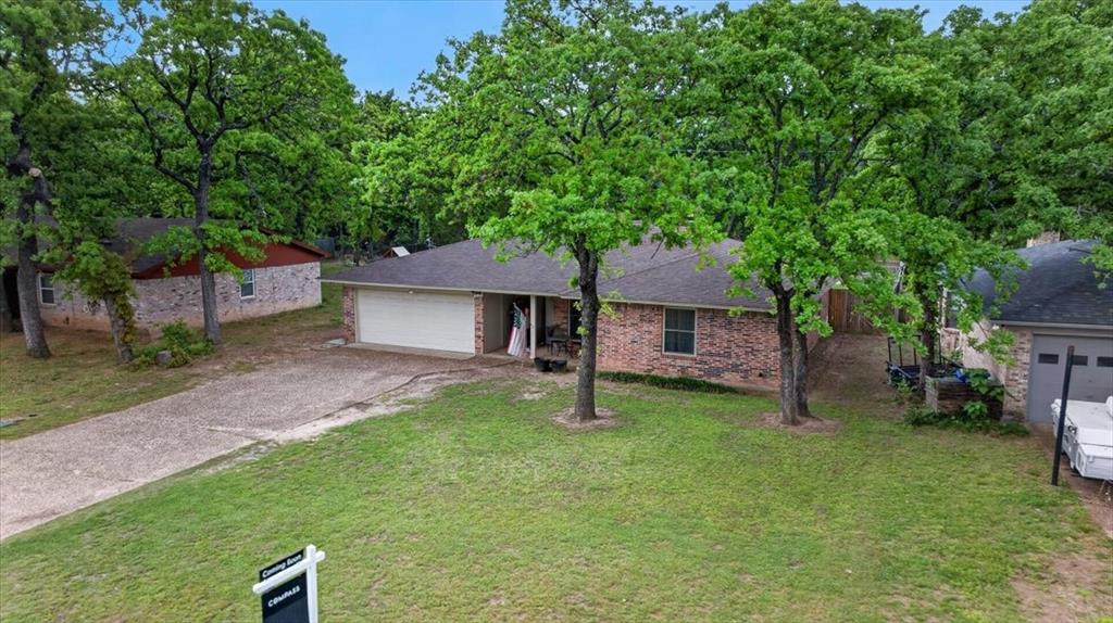 405 Pecan Street Azle, TX 76020 - Photo 32 of 33 Single story home with driveway, a garage, and a front lawn