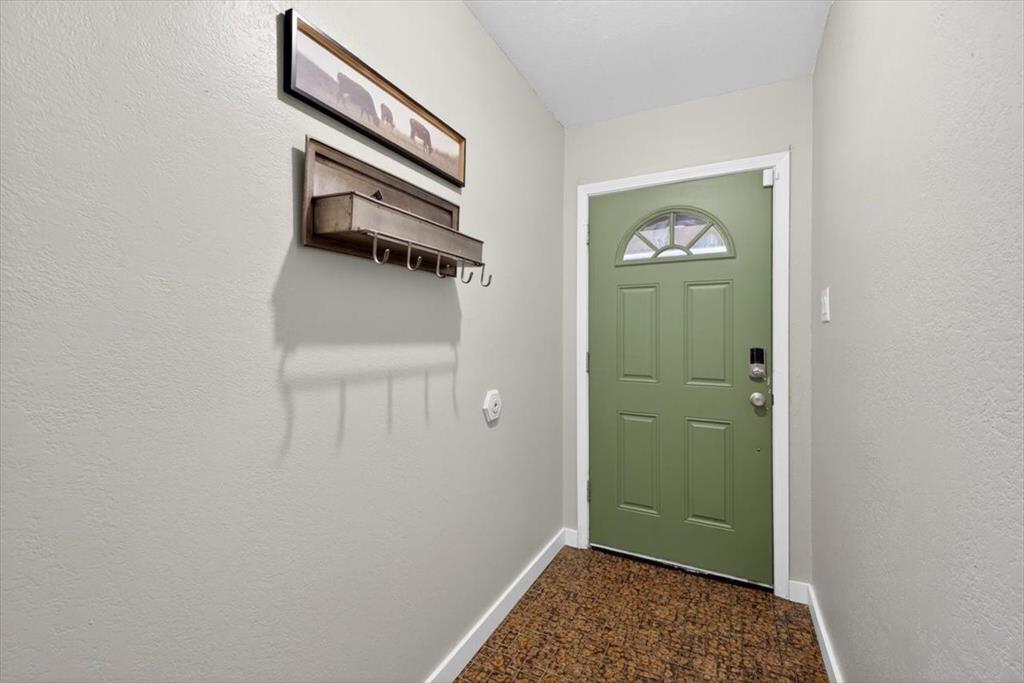 405 Pecan Street Azle, TX 76020 - Photo 5 of 33 Entryway with baseboards and a textured wall