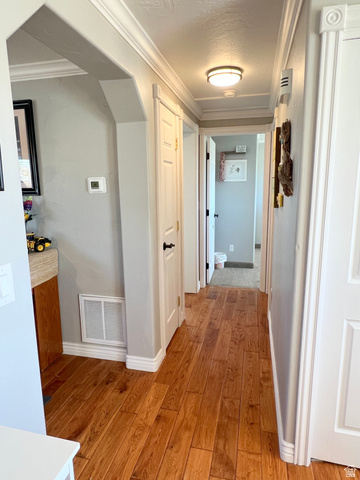 1852 East 3500th Street South Vernal, UT 84078 - Photo 18 of 46 Hallway featuring crown molding and light wood-style flooring