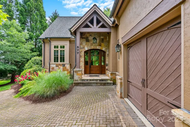 a living room with fireplace furniture and a large window