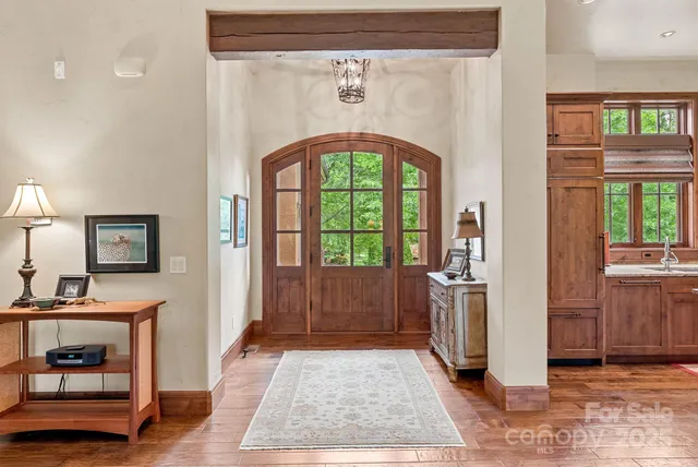 a living room with furniture large windows and a fireplace