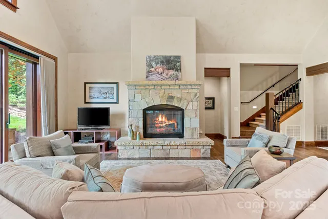 a dining room with furniture a chandelier and wooden floor