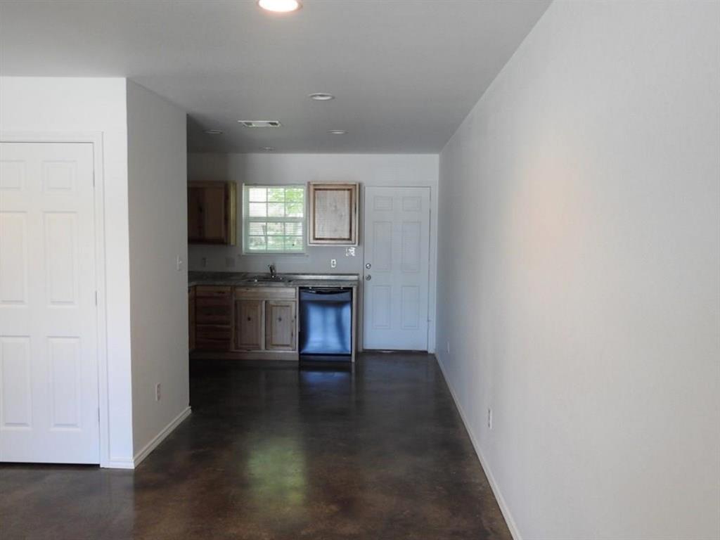 704 Seven Oaks Road Bonham, TX 75418 - Photo 11 of 11 an empty room with wooden floor and a window