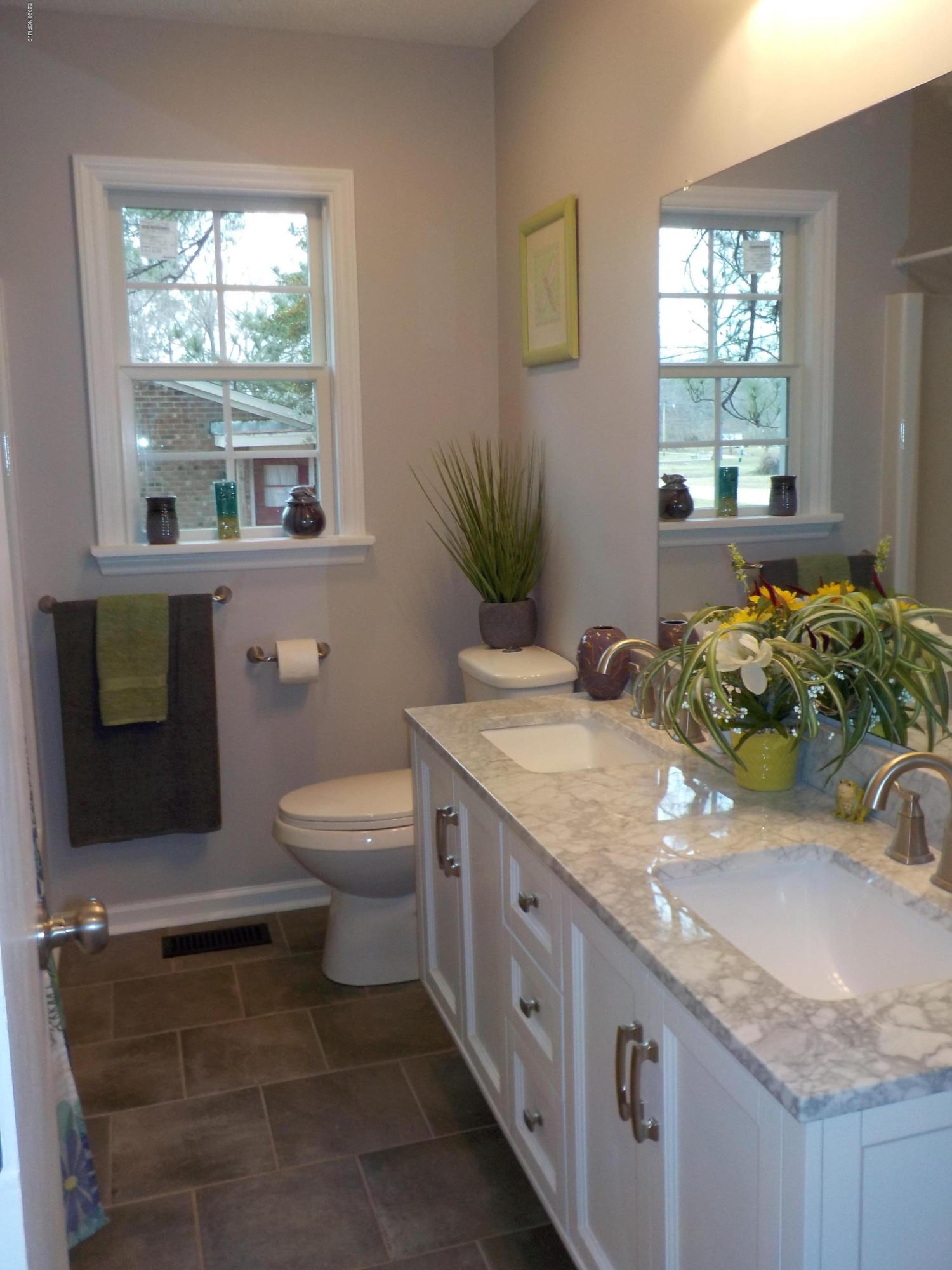 604 Mill Branch Road Rocky Mount, NC 27803 - Photo 11 of 24 bathroom with tile floor, new commode, mirror, light fixture