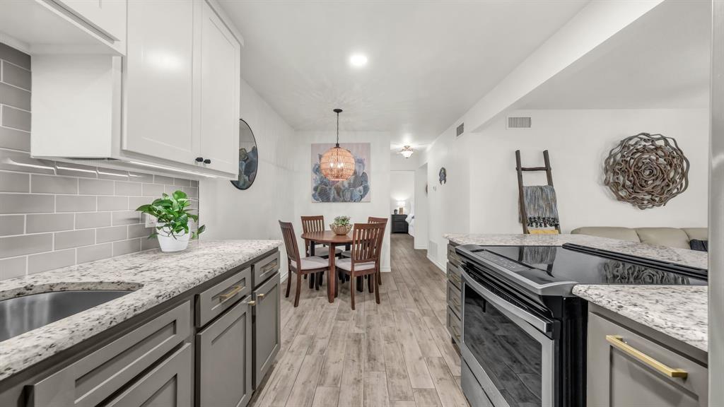 3059 Hells Gate Loop, Unit 7 Strawn, TX 76475 - Photo 14 of 36 a kitchen with a table and chairs in it