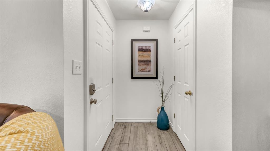 3059 Hells Gate Loop, Unit 7 Strawn, TX 76475 - Photo 17 of 36 a view of bedroom with a bed and wooden floor