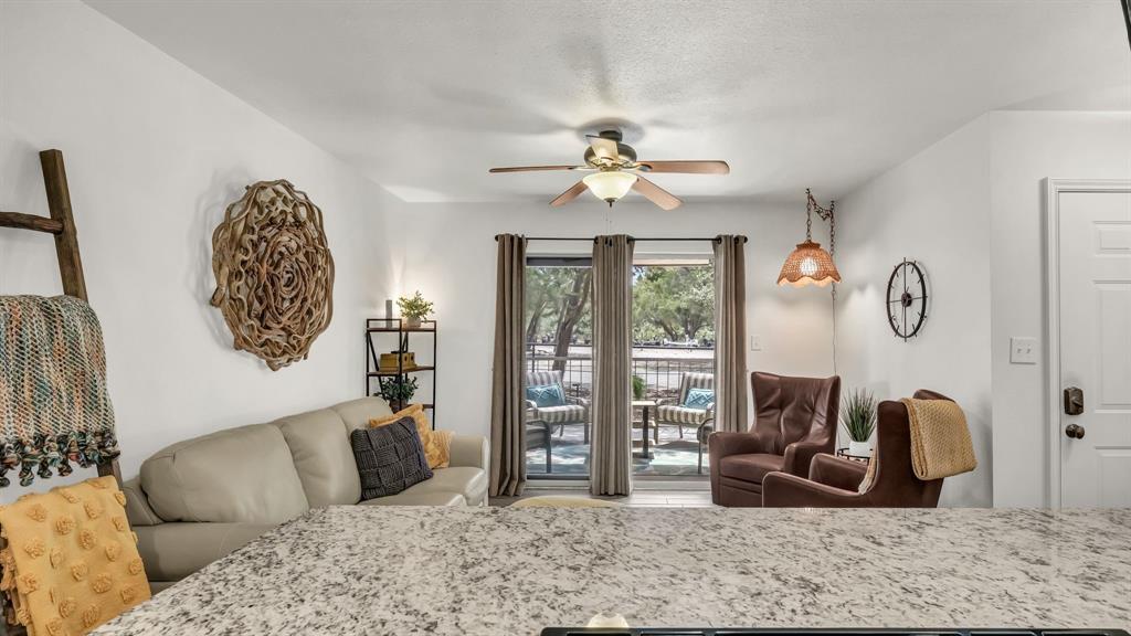 3059 Hells Gate Loop, Unit 7 Strawn, TX 76475 - Photo 2 of 36 a living room with furniture a couch and wooden floor