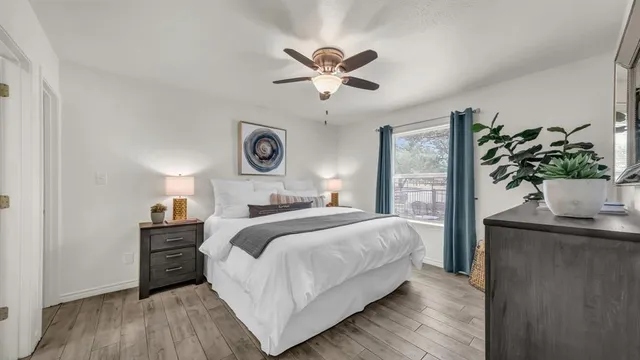 a bedroom with bed and a potted plant