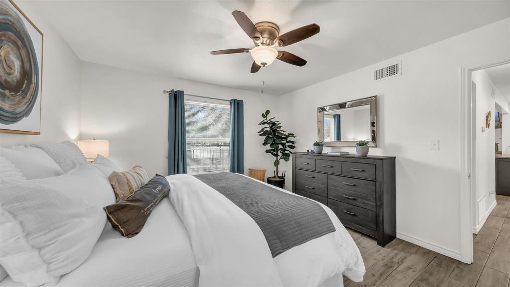 3059 Hells Gate Loop, Unit 7 Strawn, TX 76475 - Photo 23 of 36 a bedroom with a bed and a dresser