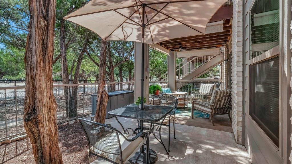 3059 Hells Gate Loop, Unit 7 Strawn, TX 76475 - Photo 28 of 36 a view of patio with a table chairs and a backyard