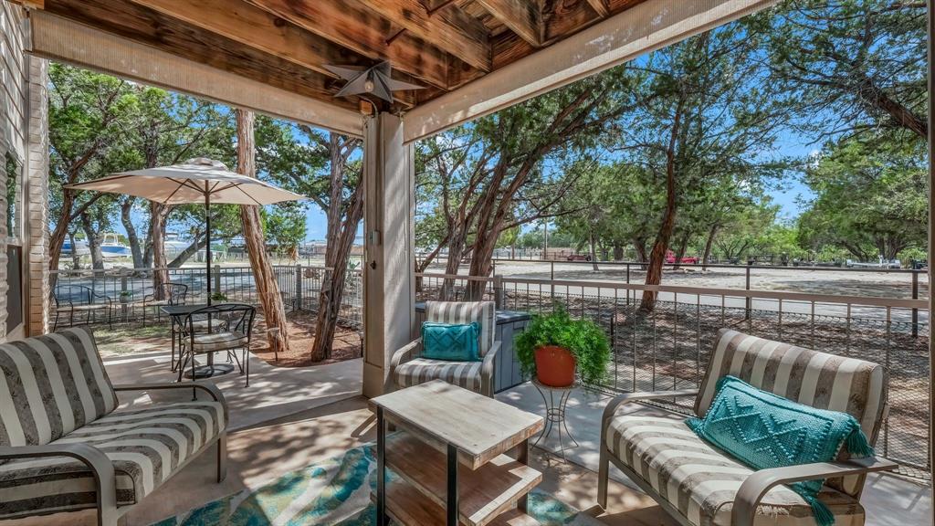 3059 Hells Gate Loop, Unit 7 Strawn, TX 76475 - Photo 29 of 36 a view of a patio with couches chairs and a potted plant