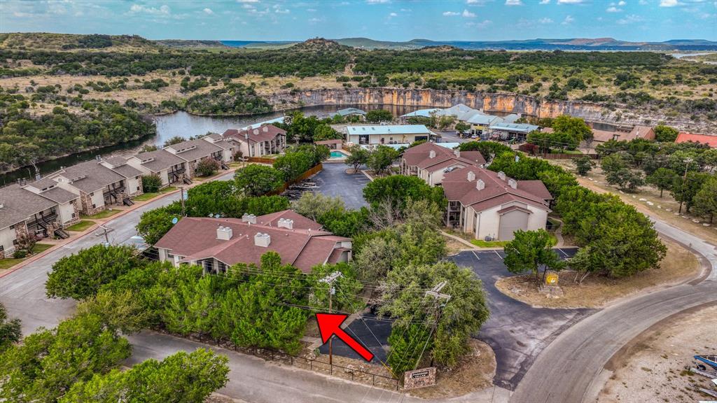 3059 Hells Gate Loop, Unit 7 Strawn, TX 76475 - Photo 35 of 36 an aerial view of residential houses with outdoor space and trees