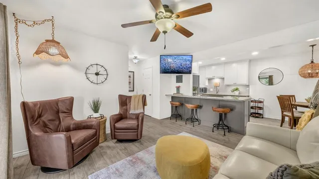 a living room with furniture a rug and a window