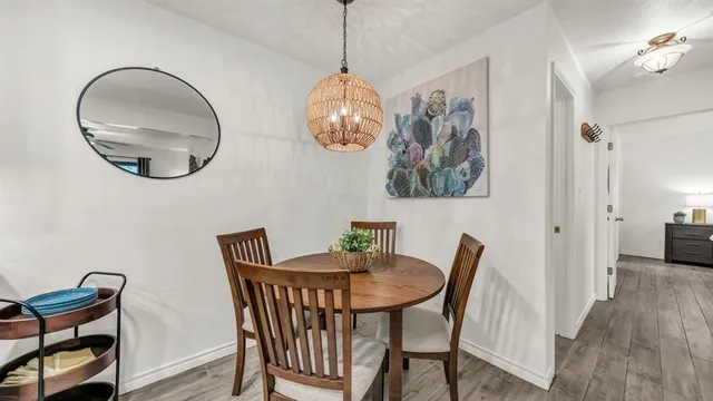 a view of a dining room with furniture and wooden floor