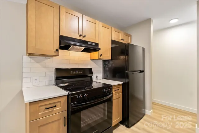 a kitchen with a refrigerator stove and microwave