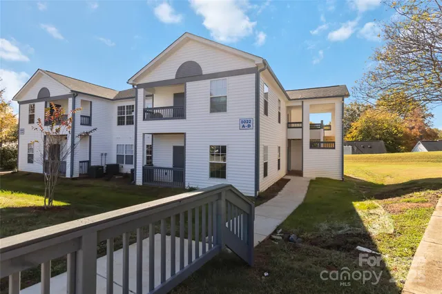 a view of a brick house with a yard