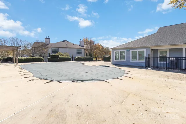 a view of a house with a yard covered in snow