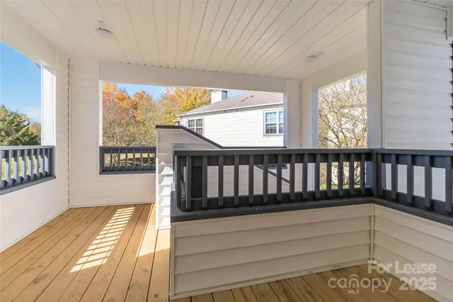 a view of a balcony with wooden floor