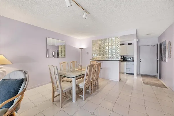 a view of a dining room with furniture and a kitchen
