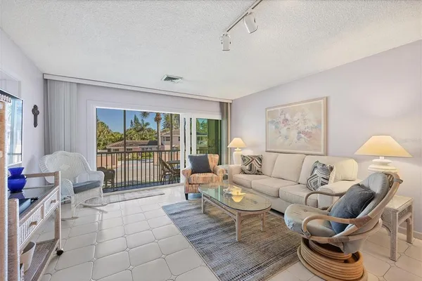 a living room with furniture and a floor to ceiling window