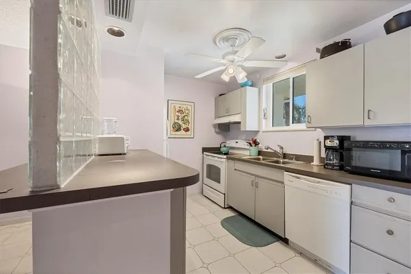 a kitchen with cabinets a sink and appliances