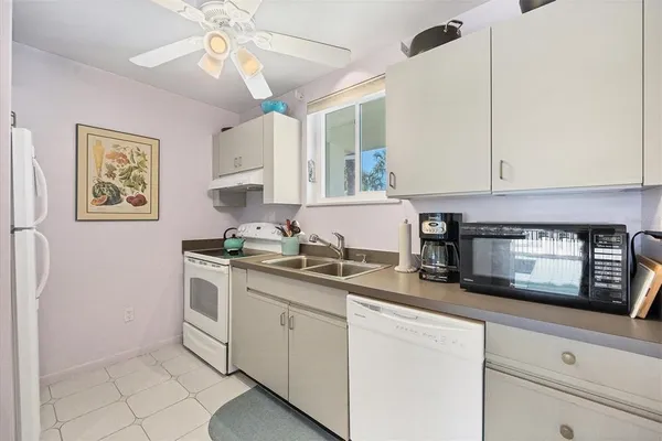 a kitchen with stainless steel appliances granite countertop a sink a stove a microwave and cabinets