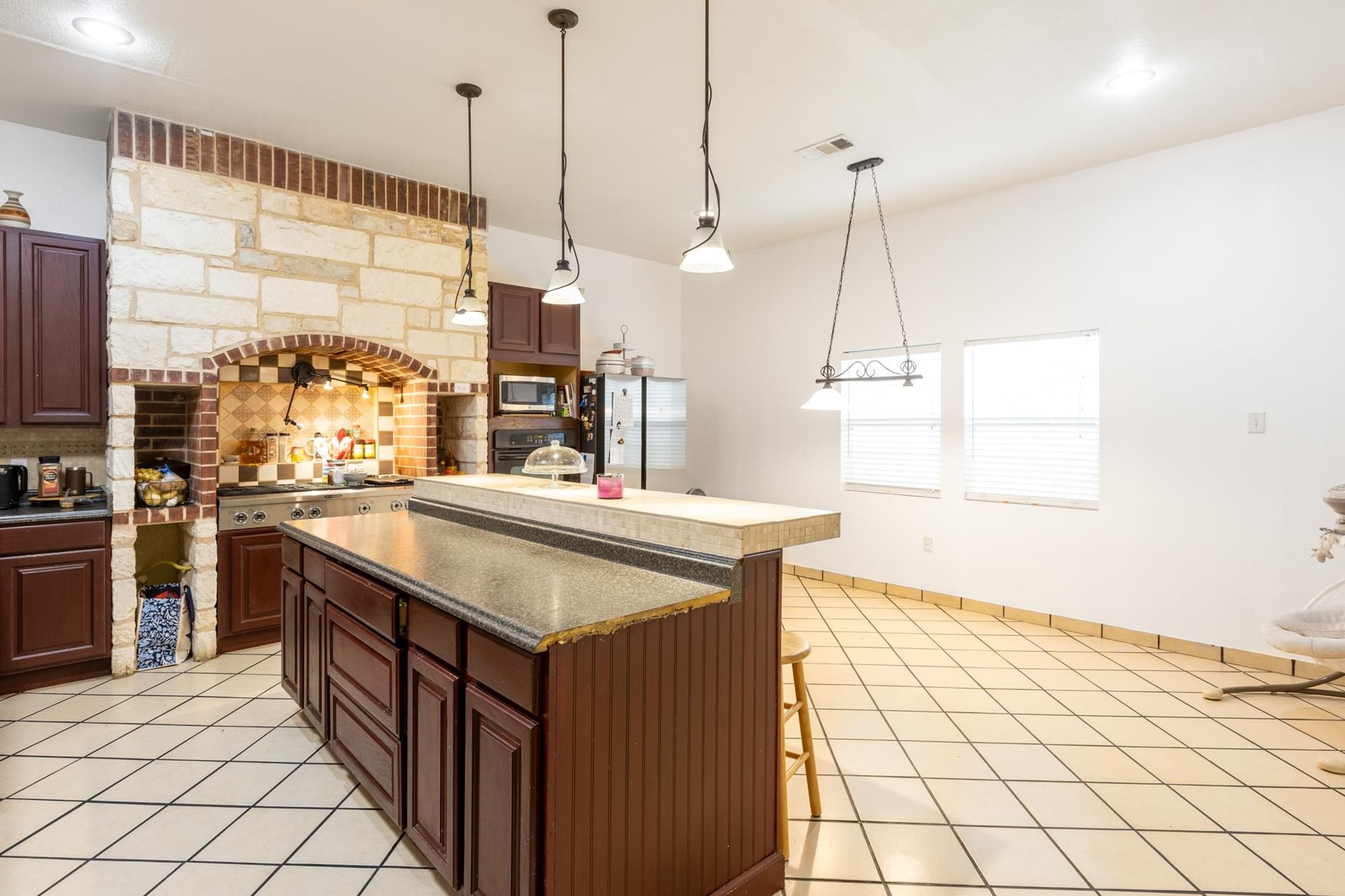 176 Old Lexington Road, Unit C Elgin, TX 78621 - Photo 10 of 31 a kitchen with stainless steel appliances granite countertop a sink and a stove