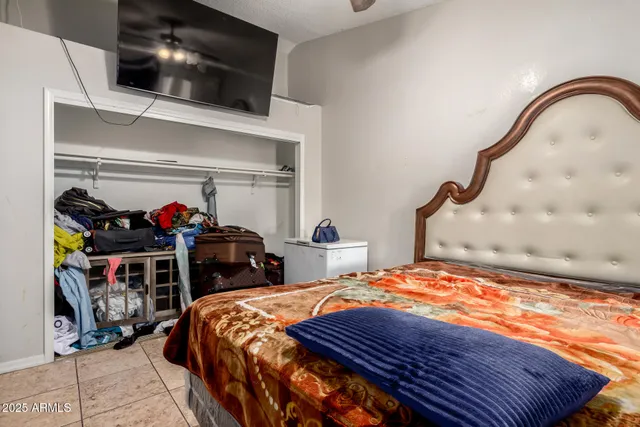 a bedroom with a bed and a television