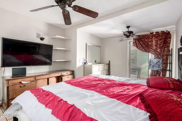 a bedroom with a bed and a flat screen tv