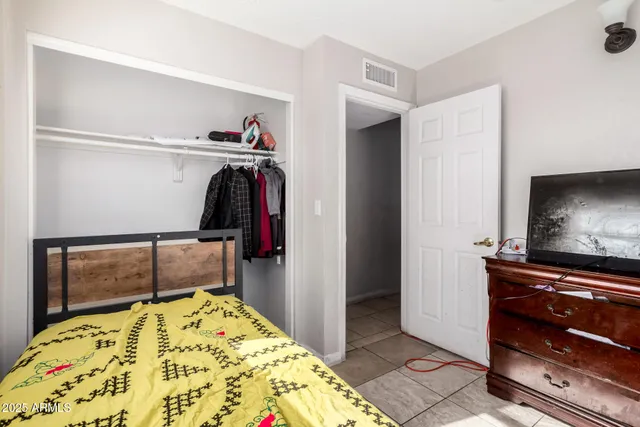 a bedroom with a bed and a flat screen tv
