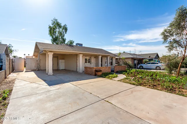 a front view of a house with a yard and a garage