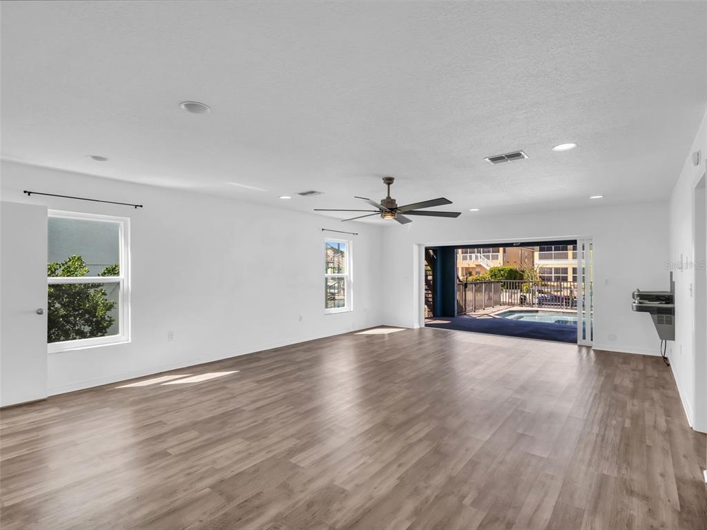 6241 Bayside Drive New Port Richey, FL 34652 - Photo 37 of 78 a view of an empty room with window and wooden floor